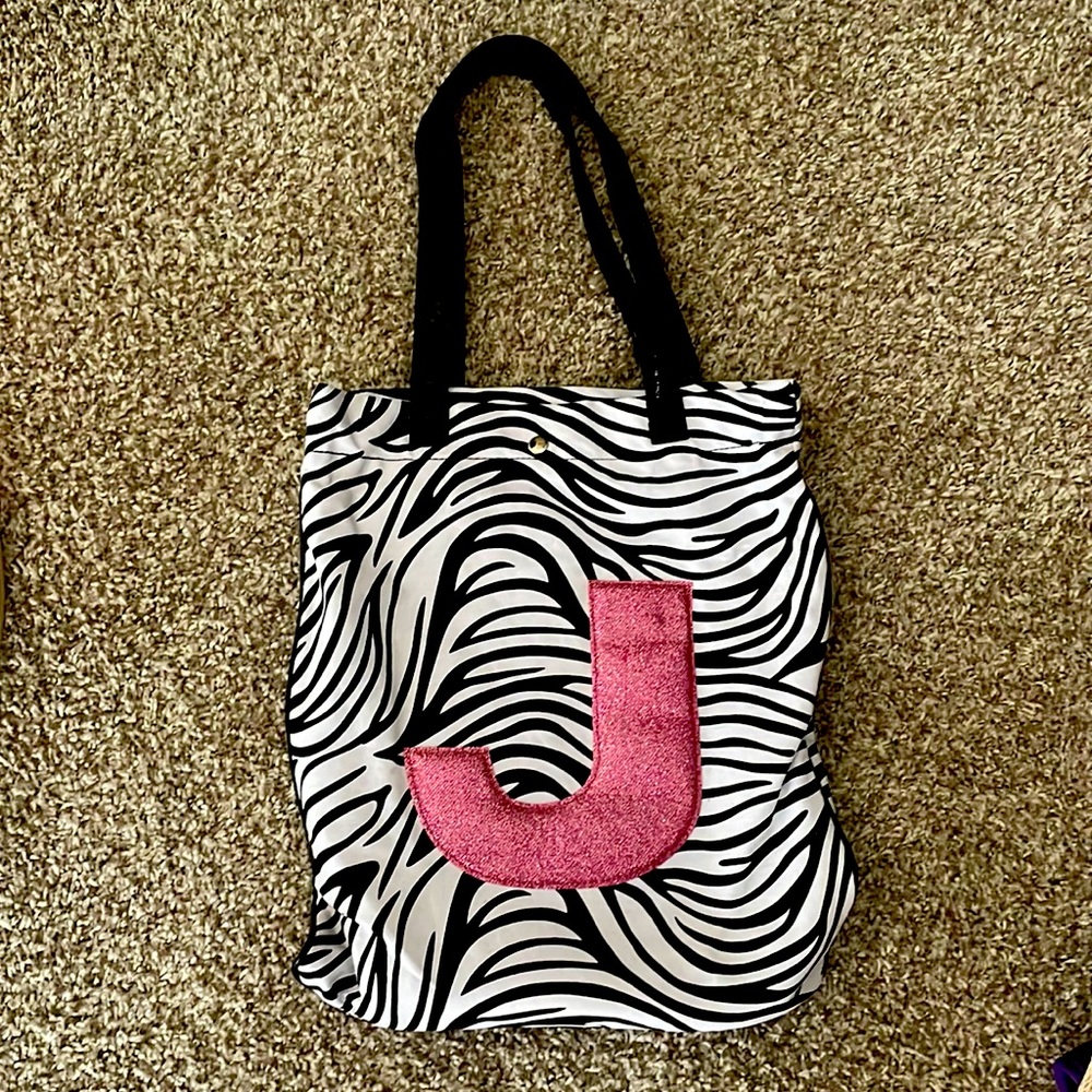 Zebra striped bag monogramed with a pink sparkly letter J & working silver snap.